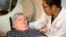 Judith Chase Gilbert is loaded into a PET scanner by a nuclear medicine technologist at Georgetown University Hospital in Washington D.C., May 19, 2015. Gilbert shows no signs of memory problems but volunteered for a new kind of scan as part of a study peeking into healthy brains to check for clues about Alzheimer's disease.