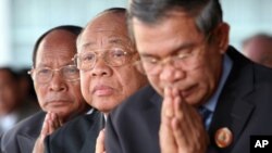 Chea Sim, center, president of the ruling Cambodian People's Party, Heng Samring, rear left, the party honorary president, Hun Sen, foreground, the party's vice president and the prime minister of the Cambodian government, file photo. 