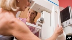 FILE - A woman is seen undergoing a mammogram.