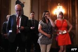 Erica Smegielski (2nd R), daughter of slain principal Dawn Hochsprung of Sandy Hook Elementary School, wipes away tears as she listens to a news conference on gun control at the Capitol in Washington, D.C., June 20, 2016.
