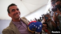 FILE - Venezuelan opposition leader Henrique Capriles smiles as he arrives for a news conference in Caracas, Dec. 7, 2015.