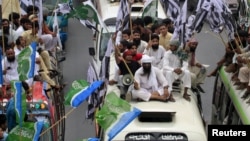 Supporters of the Defense of Pakistan Council take part in a rally against the reopening of NATO supply lines in Lahore, Pakistan, July 8, 2012. 