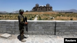 FILE - An Afghan National Army soldier stands guard after the inauguration of the reconstruction project to restore the ruins of historic Darul Aman palace, in Kabul, Afghanistan, May 30, 2016