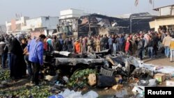 People gather at the site of a car bomb attack at a vegetable market in eastern Baghdad, Iraq Jan. 8, 2017. 