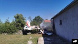 A Croatian air force plane burns after crashing in Biljane, Croatia, May 7, 2020. 