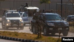 A black car carrying former Pakistani President Pervez Musharraf arrives at the Special Court formed to try him for treason in Islamabad, Feb. 18, 2014.