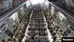 U.S. servicemen after boarding a transport plane before leaving for Afghanistan from the U.S. transit center at Manas airport, Bishkek, Kyrgyzstan, March 27, 2012.