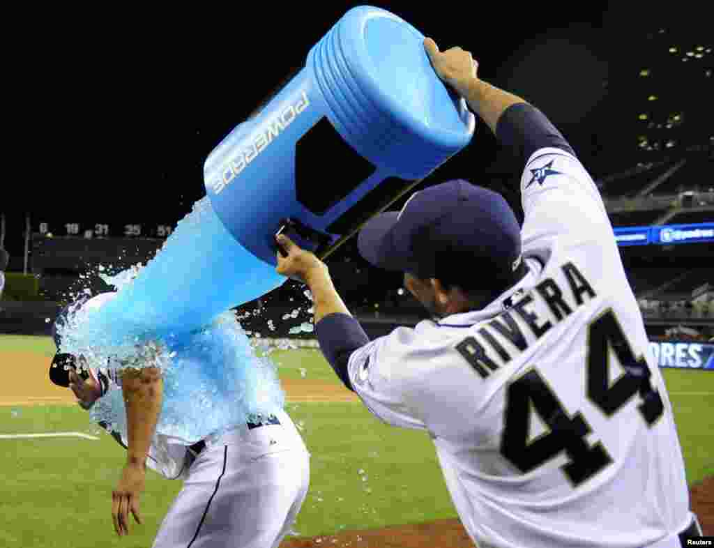 San Diego Padres center fielder Will Venable (left) is soaked with Powerade by catcher Rene Rivera (44) after Venable drove in the winning runs during the twelfth inning against the Kansas City Royals at Petco Park in San Diegom, California, May 5, 32104. The Padres won 6-5 in twelve innings. (Credit: Christopher Hanewinckel/USA TODAY Sports)