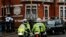 Police motorcyclists briefly stop outside the Ecuadorian embassy in London, Feb. 13, 2018.