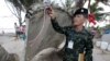 Thai army soldier inspects a piece of suspected plane wreckage which has been found off the coast of southern Thailand in Nakhon Si Thammarat province, Jan. 24, 2016. 