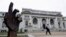 FILE - A man walks past the historic Carnegie Library building in Washington. Philanthropist Andrew Carnegie funded 3,000 public libraries in English-speaking countries. Like Carnegie, philanthropists today are pouring money into a global drive to make ci