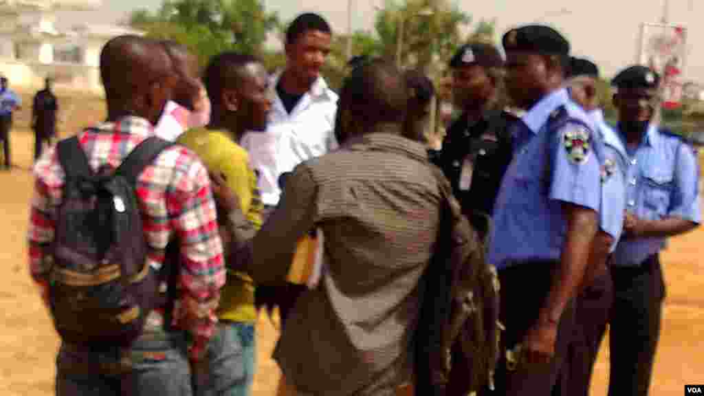 Police questioning reporters.