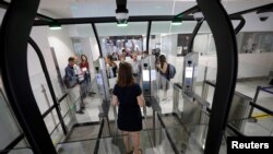 A passenger enters an airlock for facial recognition at Nice international airport's immigration section in Nice, France, July 16, 2018. 