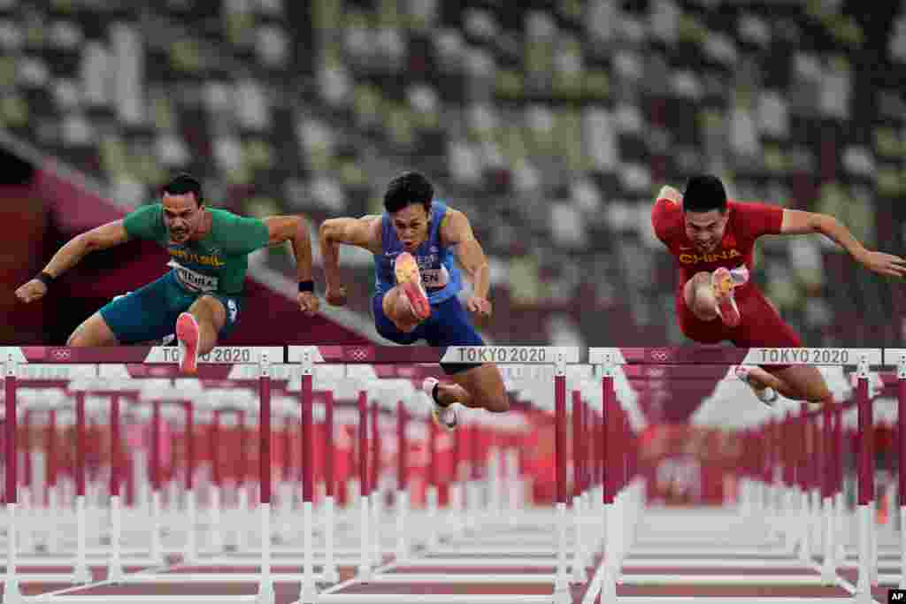 Rafael Pereira, left, of Brazil, Kuei-Ru Chen, of Taiwan, and Wenjun Xie,right, of China, compete in a heat of the men&#39;s 110-meter hurdles at the 2020 Summer Olympics, in Tokyo, Japan.