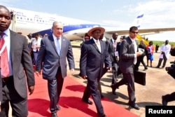 FILE - Israeli Prime Minister Benjamin Netanyahu (L) walks with Uganda's President Yoweri Museveni (R) after arriving to commemorate the 40th anniversary of Operation Entebbe at the Entebbe airport in Uganda, July 4, 2016.