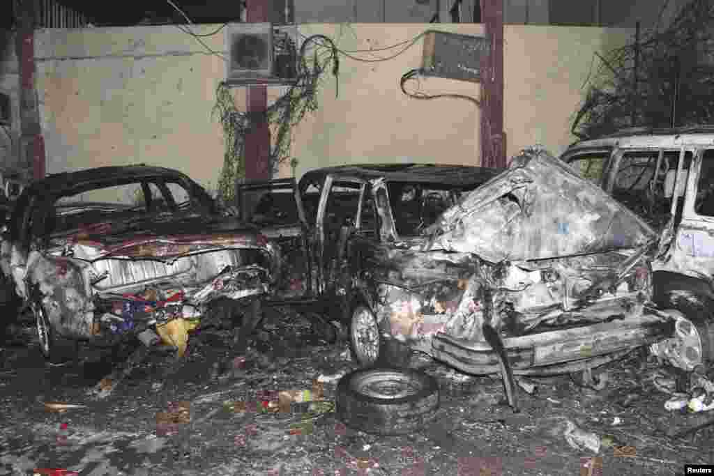 This handout photo from Syria's national news agency SANA shows cars after an explosion near police headquarters in Damascus, Syria, October 7, 2012.