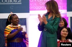 First lady Melania Trump gives an award to Tanzanian lawyer Anna Henga during the International Women of Courage (IWOC) celebration at the State Department in Washington, U.S., March 7, 2019.