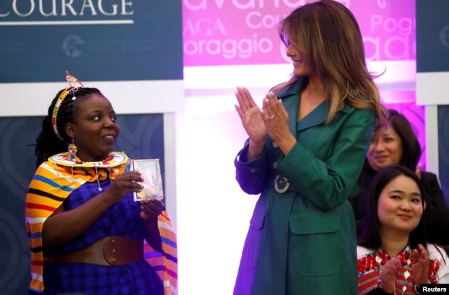 First lady Melania Trump gives an award to Tanzanian lawyer Anna Henga during the International Women of Courage (IWOC) celebration at the State Department in Washington, U.S., March 7, 2019.