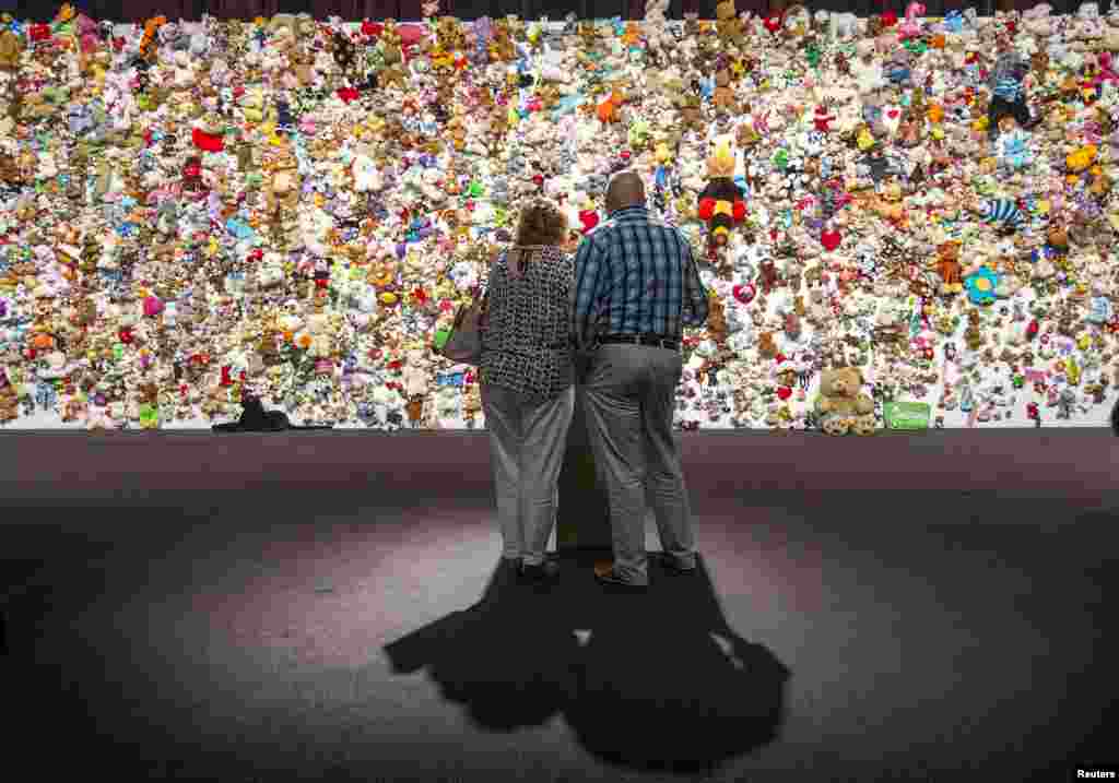 Family members and friends of victims gather in front of a &quot;hedge of compassion&quot;, made of thousands of soft toys, during a commemoration ceremony for the victims of Malaysia Airlines flight MH17 in Nieuwegein, near the city of Utrecht, the Netherlands.
