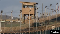 FILE - A US military member mans one of the watch towers at Camp Delta at the US Detention Center in Guantanamo Bay, Cuba. 