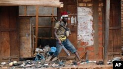 FILE - Anti-Balaka Christan youth loot the Muslim market in the PK13 district of Bangui, Central African Republic, Jan. 22, 2014. 
