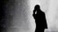 In this Oct. 11, 2012 file photo, a pedestrian talking on a cellphone is silhouetted in front of a fountain in Philadelphia.