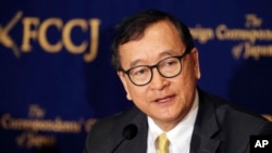 In this April 13, 2018, photo, Cambodia's self-exiled opposition leader Sam Rainsy speaks during a press conference in Tokyo.