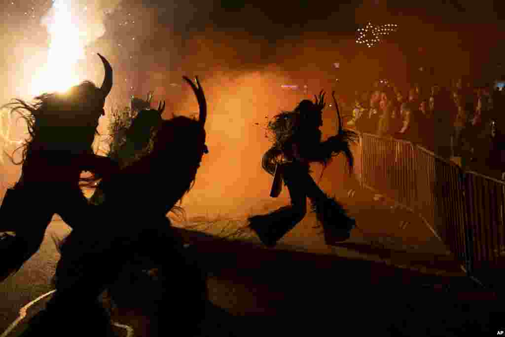 Participants wearing traditional Krampus costumes perform during a Krampus run in Hollabrunn, Austria, Nov. 30, 2024. 