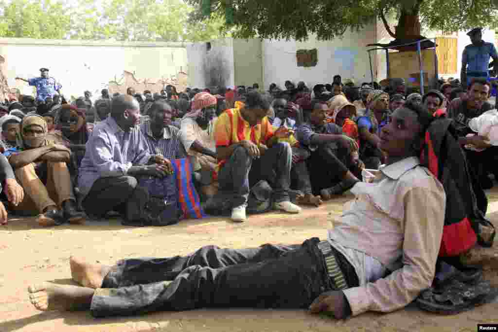 Illegal immigrants, who were abandoned by traffickers in a remote desert area, wait inside a military base in Dongola town, after being located by Sudanese and Libyan forces, May 3, 2014.