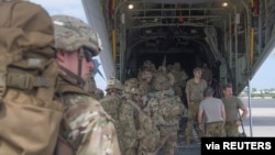 FILE - U.S. Army soldiers beginning a mission to bolster the security of Manda Bay Airfield, Kenya, after an attack by Somalia's al Shabab militants, board a transport plane in Camp Lemonnier, Djibouti, Jan.5, 2020. 