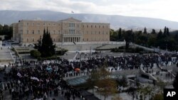 Supporters of the communist-affiliated union PAME gather outside the Greek Parliament during a protest in Athens, Dec. 8, 2016. Public services in Greece have been disrupted by a general strike called by unions against ongoing austerity measures.