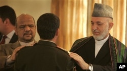 Afghan President Hamid Karzai, right, and first Vice President Muhammad Qasim Fahim, left, participate in a function promoting members of the Afghan security forces at the presidential palace in Kabul, 02 Oct 2010