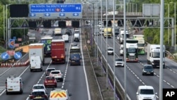 FILE - Traffic moves along the M6 motorway near Birmingham, May 18, 2020. Trade associations call for urgent talks with the government to allay concerns over preparations for Brexit, that may threaten supplies of critical goods caused by border controls.