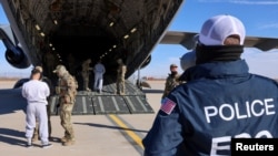 Migrants are checked before they board a U.S. military aircraft in Fort Bliss, Texas, headed to a detention facility at Guantanamo Bay, Cuba, Feb, 4, 2025. (U.S. Department of Homeland Security handout via Reuters)