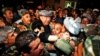 FILE - General Abdul Rashid Dostum, center in gray turban, leader of Afghanistan's Uzbek community arrives at the Kabul international airport, Aug. 16, 2009.