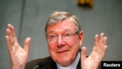 FILE - Cardinal George Pell talks during a news conference at the Vatican July 9, 2014. Australian Cardinal George Pell, too weak to travel to his homeland, testified Sunday from a hotel in Rome via a videolink to the Royal Commission into Institutional Responses to Child Sexual Abuse in Sydney. 