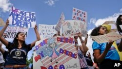 FILE - Supporters of Deferred Action for Childhood Arrivals demonstrate in front of the White House, Sept. 9, 2017.