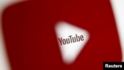 A 3-D-printed YouTube icon is seen in front of a displayed YouTube logo in this illustration taken Oct. 25, 2017. 