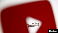 FILE - A 3-D-printed YouTube icon is seen in front of a displayed YouTube logo in this illustration taken Oct. 25, 2017. 