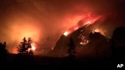 In a photo provided by Inciweb shows the Eagle Creek wildfire burning in the Columbia River Gorge east of Portland, Oregon, Sept. 4, 2017.