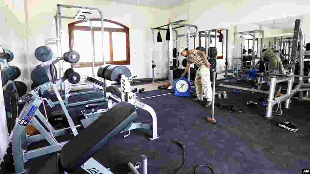 A member of the Dawn of Libya Islamist militia stands at the gym of a villa at the U.S. diplomatic compound after members of the group moved into the complex of several villas in southern Tripoli to prevent it from being looted, Aug. 31, 2014.