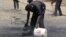 Workers outside the Qurtoba conference hall clean up debris after demonstrations by Sudanese university students and citizens yesterday in the capital Khartoum, Sudan, June 24, 2012. 