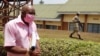 FILE - Paul Rusesabagina, portrayed as a hero in a Hollywood movie about Rwanda's 1994 genocide, is escorted in handcuffs from the courtroom in Kigali, Rwanda, Sept. 25, 2020. 