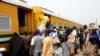 FILE - Passengers rush to board train enroute Lagos-Kano at Mokwa Station on February 8, 2013.