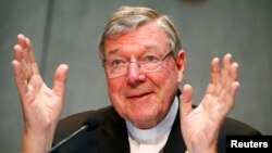 FILE - Cardinal George Pell talks during a news conference at the Vatican, July 9, 2014.