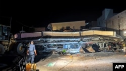 Rescue workers are seen at the site of a collapsed building after an earthquake struck Port Vila, the capital city of Vanuatu, on Dec. 18, 2024.