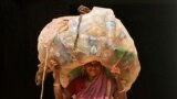 An Indian woman carries a sack of used plastic bottles to be sold at a recycling plant in the eastern Indian city of Bhubaneswar.