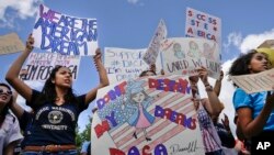 FILE - Supporters of the Deferred Action for Childhood Arrivals program demonstrate in front of the White House, Sept. 9, 2017.