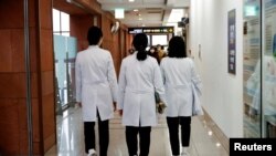 FILE - Medical workers walk at Severance Hospital in Seoul, South Korea, Feb.21, 2024.