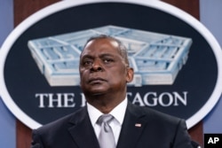 FILE - Secretary of Defense Lloyd Austin listens to a question as he speaks during a media briefing at the Pentagon, Feb. 19, 2021, in Washington.